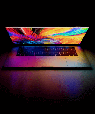 Laptop half way open with colourful swirl on screen